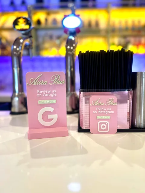 Pink NFC display on the bar at Aura Bar