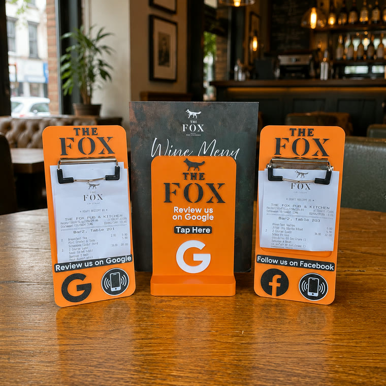 Orange bill holders either side of a wine menu holder on a table at The Fox Pub and Kitchen