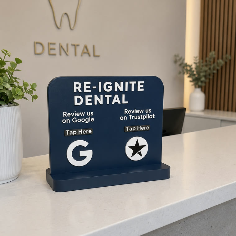 A navy Re-Ignite Dental review display on a reception counter